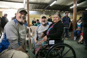 Rick and Tom fitting woman for new wheelchair